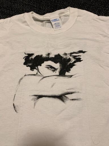 On a white t-shirt, a partial figure had been painted is the style of Cabanel's 1847 "Fallen Angel."