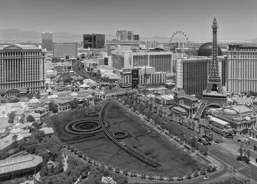 The Las Vegas Strip by day, complete with a fake Eiffel Tower, a ferris wheel, a creepy sphere, and an inappropriately large fountain. Best viewed from a safe distance.